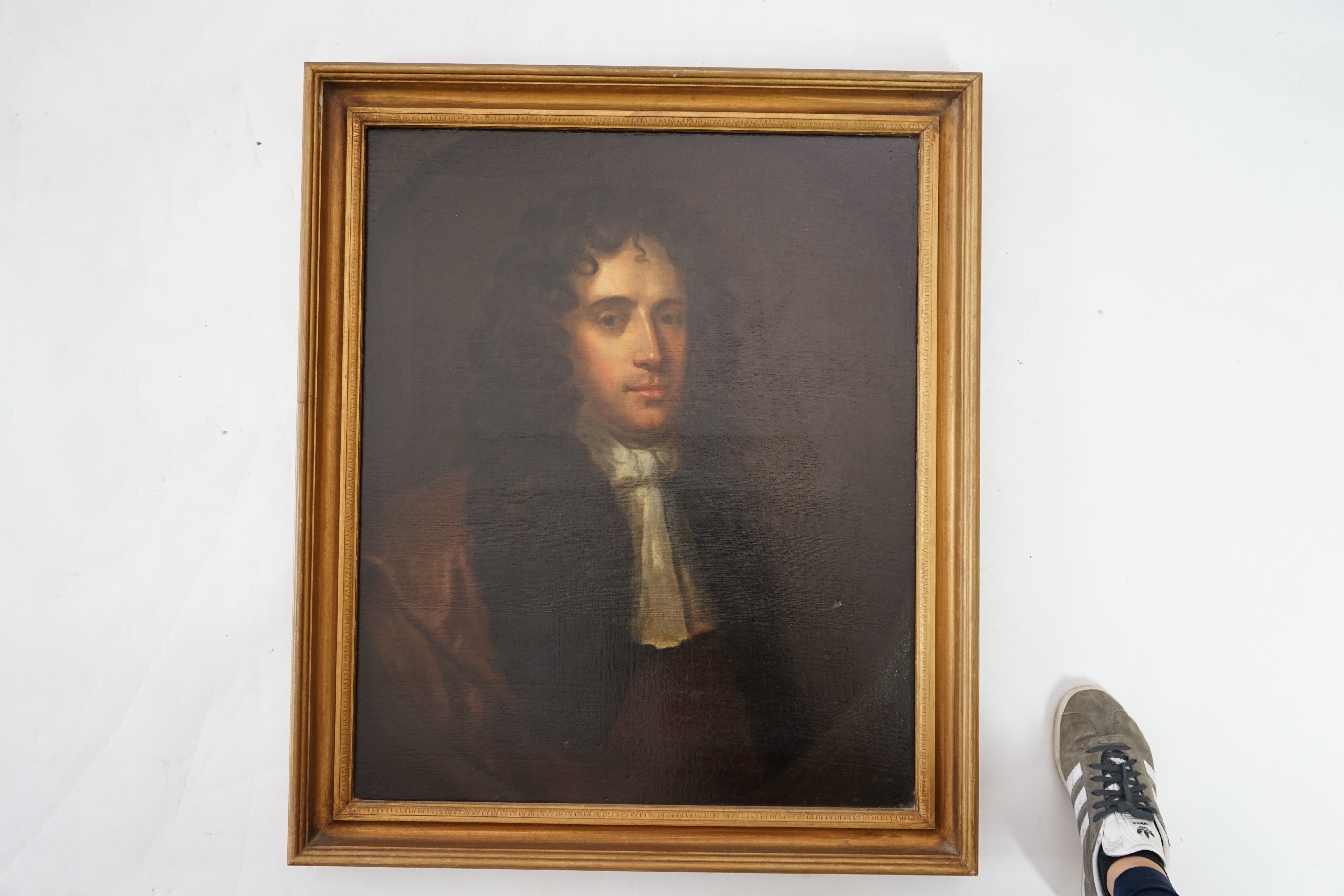 Follower of Sir Peter Lely (1618-1680), Half length portrait of a gentleman in a brown coat and white stock, oil on canvas